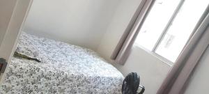 a bedroom with a bed next to a window at Condomínio Citta COP30 in Marituba
