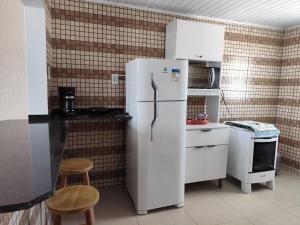 a kitchen with a white refrigerator and a stove at Apto Dom Pedrito in Dom Pedrito