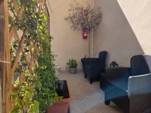 a hallway with chairs and potted plants at Cà Fiamma 2 in Casale Monferrato