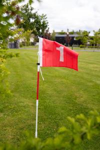 a red and white flag on a golf course at Cherry Tree Lodge in Limavady +73 photos