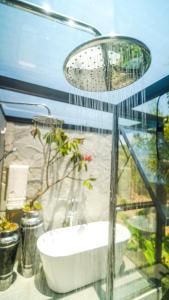 a bathroom with a bath tub and a sink at Zamaya Bangalôs in Sao Jorge