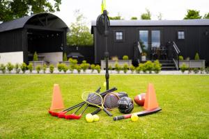 a bunch of tennis equipment sitting on the grass at Cherry Tree Lodge in Limavady