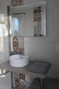 a bathroom with a sink and a mirror at Escale19 in Milly-la-Forêt +8 photos
