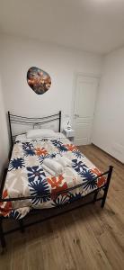 a bedroom with a bed with a comforter on it at San Paolo Hideout in Rome