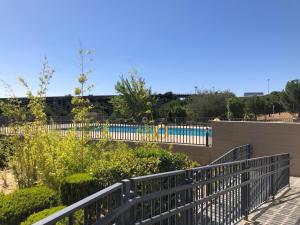 a black fence with a pool in the background at Lujoso Loft La Moraleja in Madrid
