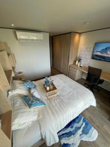 a bedroom with a large white bed and a desk at Escapes in Simpson Bay +13 photos