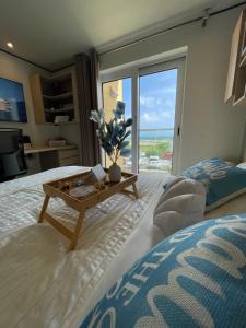 a bedroom with a bed and a table with a view at Escapes at The Emerald in Simpson Bay