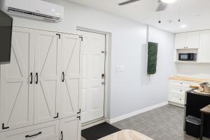 a kitchen with white cabinets and a refrigerator at Cozy with Private Entry Near Fort Myers & Airport in Lehigh Acres +13 photos