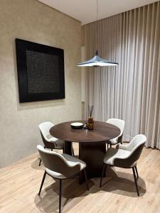 a dining room with a table and chairs at Luxury 2BR - Steps To Boulevard in Riyadh