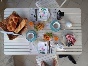 a white table with breakfast foods on it at Escale19 in Milly-la-Forêt