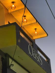 a sign on the front of a restaurant with lights at Suítes Oásis in Macau
