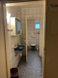 a small bathroom with a sink and a toilet at TL Gastzimmer 1 in Frankfurt +46 photos