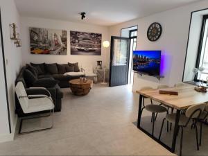 a living room with a couch and a table at Villa AIMÉ SALMCHÂTEAU in Vielsalm