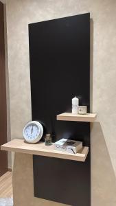 a shelf with a clock and a scale on it at Luxury 2BR - Steps To Boulevard in Riyadh