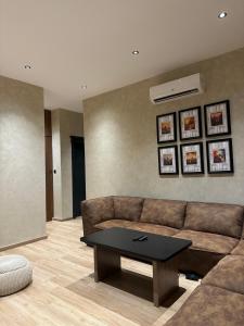 a living room with a couch and a coffee table at Luxury 2BR - Steps To Boulevard in Riyadh