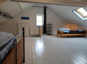 a attic room with two beds and a window at Villa AIMÉ SALMCHÂTEAU in Vielsalm