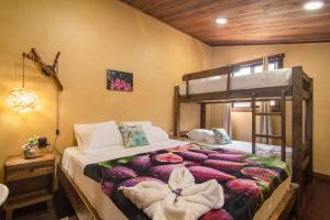 a bedroom with a bed and a bunk bed at Promisedland Tayrona Cabins Hotel in Buritaca