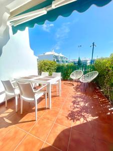 a patio with a white table and chairs on a patio at Paradise Dreams in Maspalomas