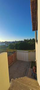 a view from the balcony of a house with stairs at Casa por do sol Flecheiras in Flecheiras