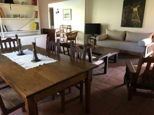 a living room with a table and chairs and a couch at La Cuadra - Puesto de Campo Argentino in Lobos