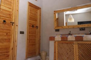 a bathroom with a mirror and a sink at Atlas Green Lodge in Imlil