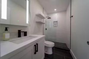 a white bathroom with a toilet and a shower at 1134 Hollywood in Hollywood +10 photos