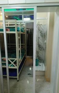 a room with two bunk beds and a glass wall at J Jireh Residences in San Jose del Monte +19 photos