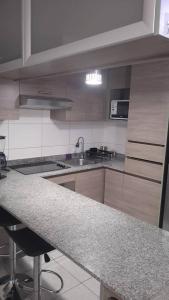a kitchen with a sink and a counter top at Matiz Cavancha II in Iquique