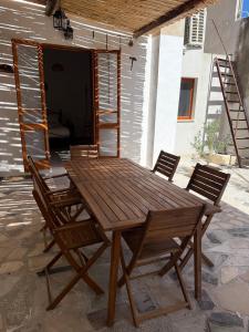 a wooden table and chairs on a patio at La Villeta di Nonna in Selargius