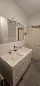 a bathroom with two sinks and a large mirror at Spacious Room with private king bathroom in Amsterdam