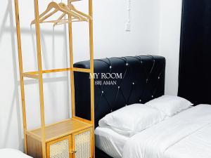 a room with a bunk bed and a ladder next to a bed at My Room Sri Aman in Kampong Lamanak