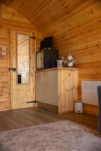 a kitchen with a refrigerator and a microwave in a room at livi pod Woodland lake in Carlton Miniott