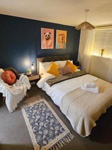 a bedroom with a large bed with yellow pillows at Wellington Modern Studio - Free Parking in Wellington
