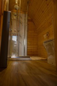 a bathroom with a shower in a wooden room at livi pod Woodland lake in Carlton Miniott +18 photos