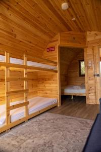 a large wooden cabin with two bunk beds in it at livi pod Woodland lake in Carlton Miniott