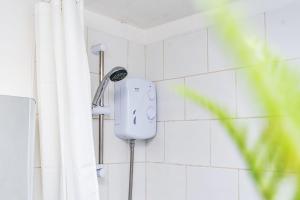 a shower head on the wall of a bathroom at Wellington Modern Studio - Free Parking in Wellington +38 photos