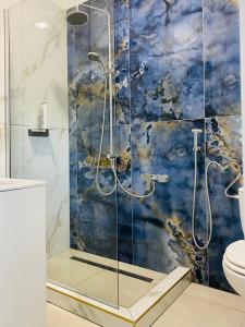 a bathroom with a shower with a blue at Patak & Stone apartman in Szentendre
