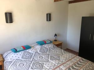 a bedroom with a bed and two pillows on it at Chalet Bordemar in Concón