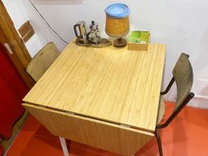 einem Holztisch mit zwei Stühlen und einer Lampe darauf in der Unterkunft Chambre privée non verrouillée dans un appartement partagé - avec chien in Straßburg