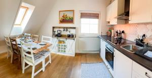 a kitchen with a table and a sink and a counter at Ferienwohnung Peters in Hünfeld