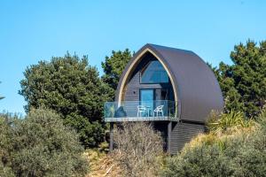 a dome house on top of a hill with trees at Perch on the Ridge by Waiheke Pure in Waiheke Island