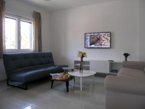a living room with a couch and a table at Apartments Mon Amour in Dubrovnik