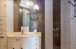 a bathroom with a sink and a shower at Zamalek Nile View in Cairo +18 photos
