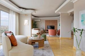 a living room with a white couch and a table at Zamalek Nile View in Cairo
