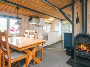 a kitchen with a wooden table and a fireplace at Seaside Escape in Sonderho - By Traum Ferienwohnungen in Fanø +27 photos