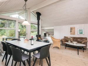 a living room with a table and chairs and a couch at 8 person holiday home in Fanø-By Traum in Fanø +28 photos
