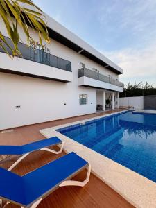 a villa with a swimming pool and a house at Modern and luxurious villa, comfort and tranquility in Saly Portudal