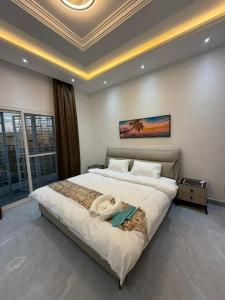 a bedroom with a large bed with a coffered ceiling at Modern and luxurious villa, comfort and tranquility in Saly Portudal