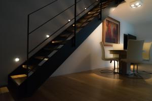 a staircase in a room with a desk and a computer at L19 Tuttlingen in Tuttlingen