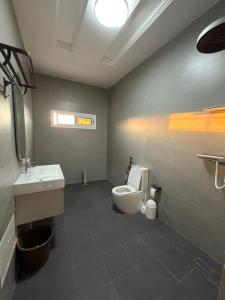 a bathroom with a toilet and a sink at Modern and luxurious villa, comfort and tranquility in Saly Portudal